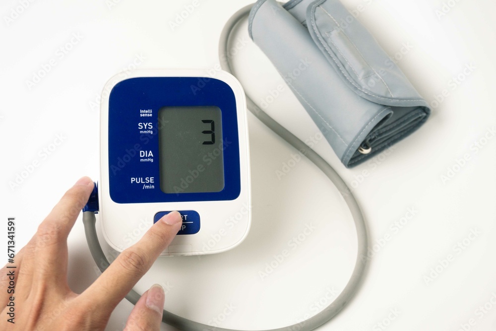 female hands check blood pressure monitor and heart rate monitor with digital manometer, isolated white background, healthcare and medical concept female hands check blood pressure monitor and heart rate monitor with digital manometer, isolated white background, healthcare and medical concept