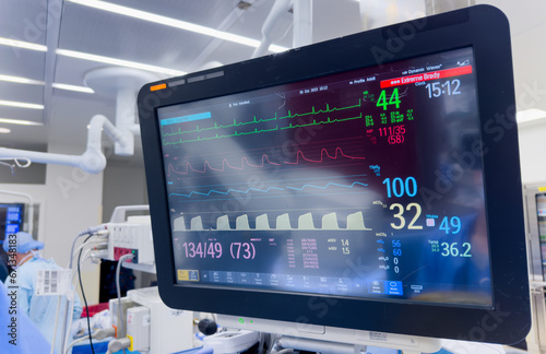 hospital monitor displaying vital signs: blood pressure, heart rate, pulse oximetry, and temperature, providing critical patient health data in a medical setting