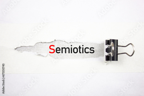 Semiotics text, acronym on a torn sheet. SEMIOTICS word scientific concept. photo