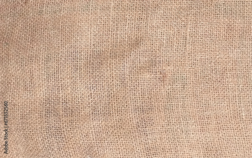 beige linen background, fabric texture for fashion design or upholstered furniture. Burlap bag material. Design element. Sacking and bagging pattern. Top view.