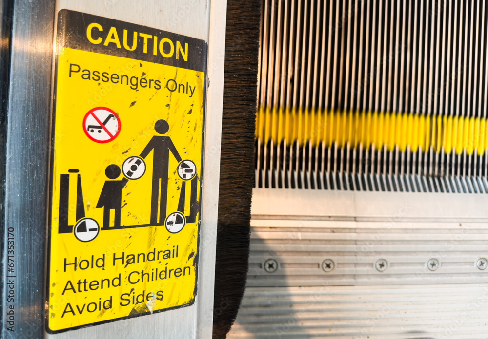 caution sign stands tall against a backdrop of hard hats and heavy