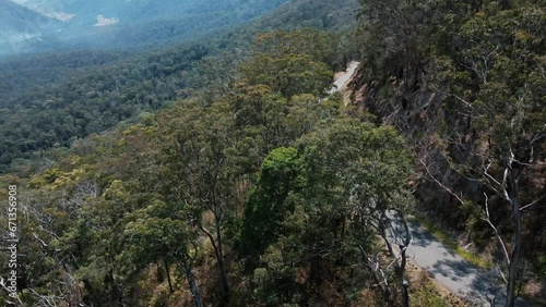 Drone aerial showing a road along  a mountain with Australian native trees photo