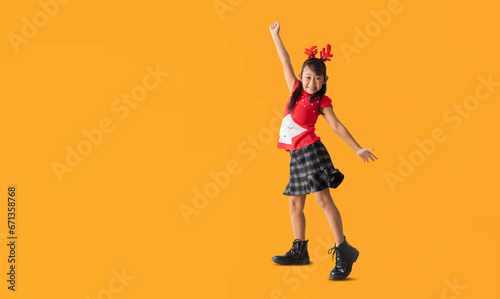 Christmas girl in dress dancing have fun, full body isolated on yellow background