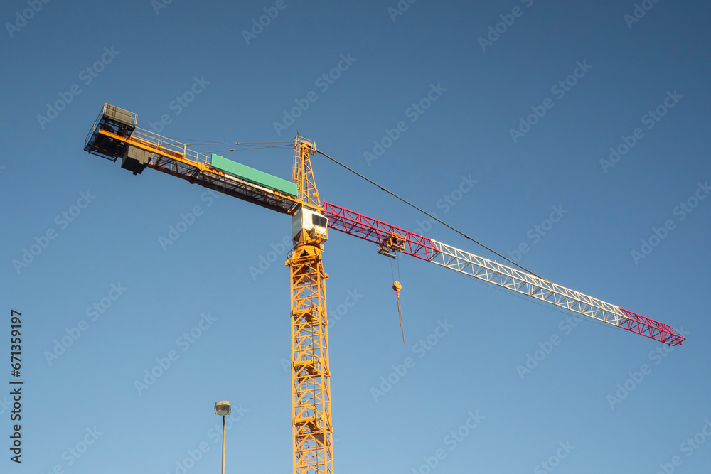 Crane on blue sky background took in sunset