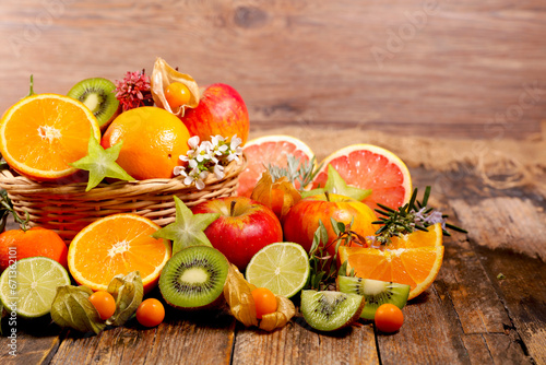 Different citrus fruit on wood background
