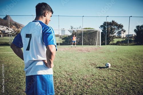 Soccer, thinking and a man on a field for a goal, sports penalty or training for a team. Fitness, focus and an athlete getting ready to kick a football during a competition for cardio, win or playing