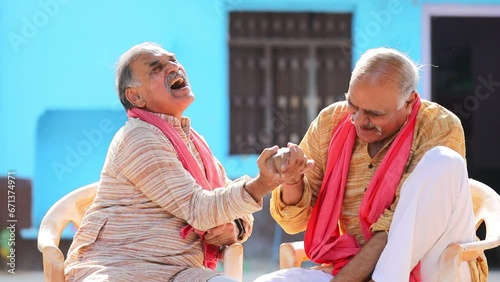 Senior farmer brother laughing and giving happy expression photo