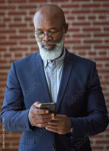 Startup, black man and manager with smartphone, online reading and connection for typing. Mature male, African American employee or leader search internet, success or small business with entrepreneur