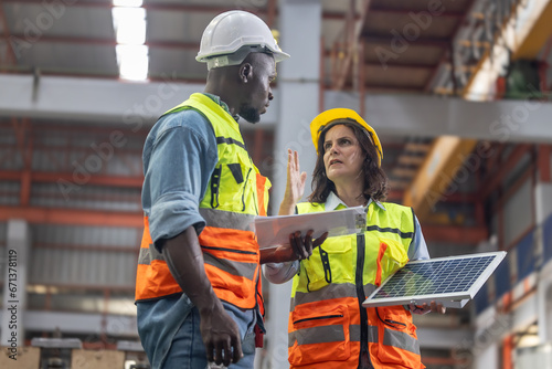 Factory metal workers install solar panels, cut costs, earn carbon credits, combat climate change.