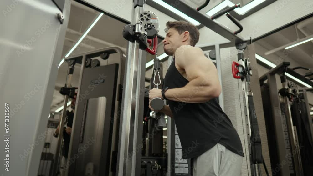 Cable Rope Tricep Extention. Middle Age Muscular Man Train Arms - low angle Cable Rope Tricep Extention. Middle Age Muscular Man Train Arms - low angle