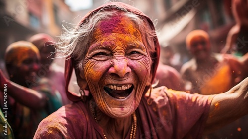 Old Indian woman dancing in the street of India  Holi festival  Phagwah  Bhojpuri  multi-colored powder   festival of colors