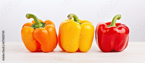 Three fresh peppers red yellow and orange are provided as healthy food samples