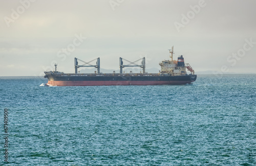 Landscape view of a large and heavy cargo container ship in the San Francisco Bay for the transport of crude oil. International transport of import and export goods and port navigation experience.