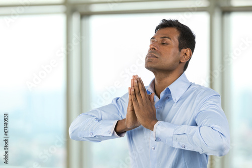 Indian Business man meditating.