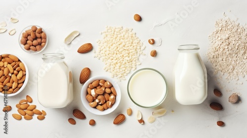 Food and drink, health care, diet and nutrition concept. Assortment of organic vegan non dairy milk from nuts, oatmeal, rice, soy in glasses on a kitchen table. Copy space top view flat lay background