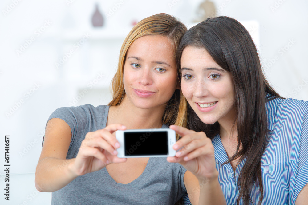 two teen girls taking selfie