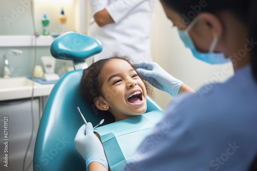 dentist checking teeth of little girl child