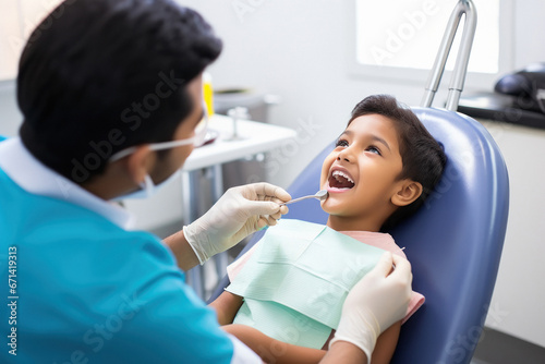 Dentist checking little boy teeth at clinic