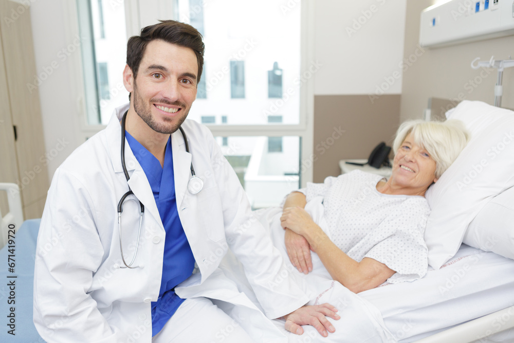 portrait of doctor with patient in background portrait of doctor with patient in background