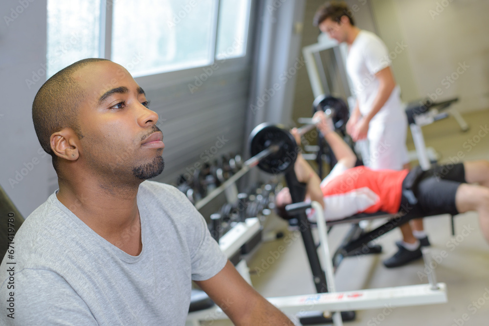 man resting from gym exercises