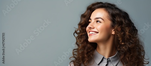 Smiling woman in business attire glancing left photo