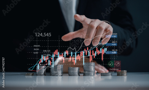 investment and finance concept, businessman touching virtual trading graph and blurred light on hand, stock market, profits and business growth.
