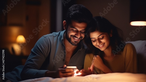 young indian couple using smartphone at home