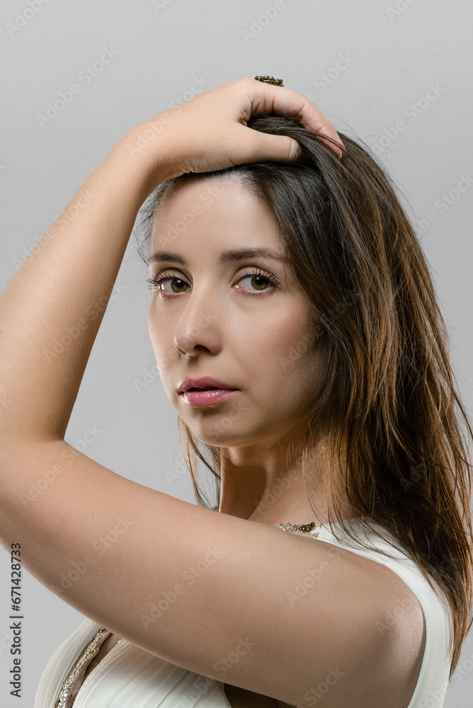 Fototapeta premium Woman in the retro style white dress posing on the white background.