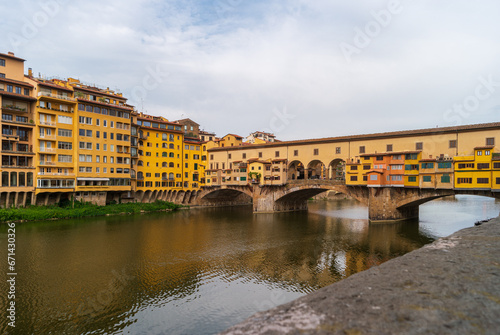 Florence, Italy. View of the Ponte Vecchio bridge over the Arno river on a summer day. Famous tourist attraction in the Italian region of Tuscany. © Kristina Maikova
