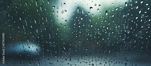 The view of rain falling on the windshield while looking inside the road photo
