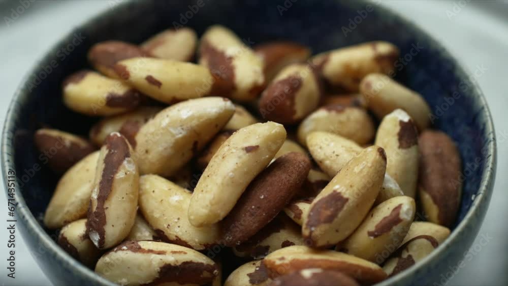 Brazil nuts rotating in bowl. raw wholefood and healthy foods. Whole food cooking for vegetarian and plant-based diet. Shallow depth of field HD image of healthy vegan food. Brazil nuts rotating in bowl. raw wholefood and healthy foods. Whole food cooking for vegetarian and plant-based diet. Shallow depth of field HD image of healthy vegan food.