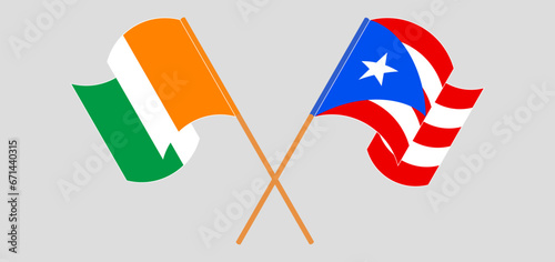 Crossed and waving flags of Ivory Coast and Puerto Rico