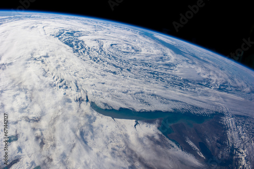 Fotografie Aerial View of Earth's Atmosphere with Cloud Formations and Oceanic Swirls from Space