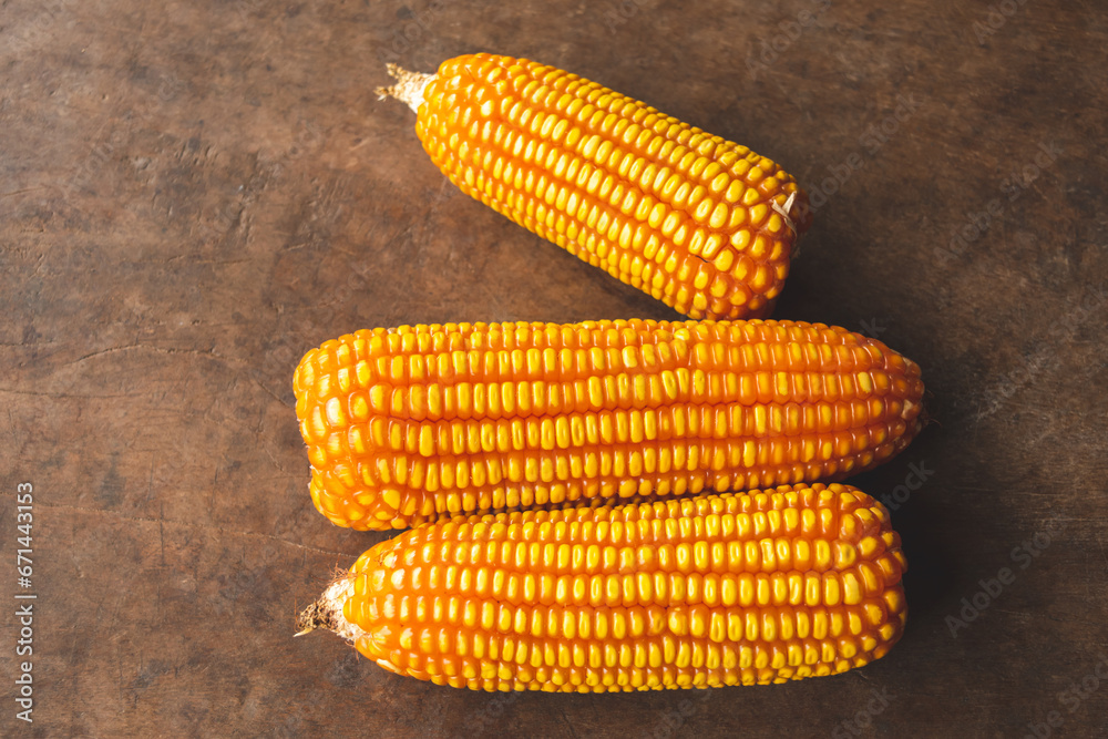 Top view of dry corn on the wood background
