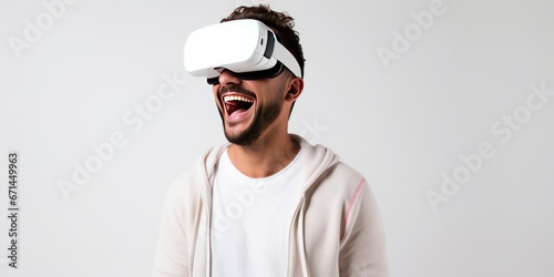 Portrait of happy man wearing virtual reality glasses isolated on white background with copy space. Banner template of smiling man with VR goggle © Neda Asyasi
