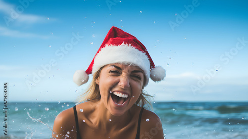 Smiling girl in santa claus hat on ocean beach © Taisiia