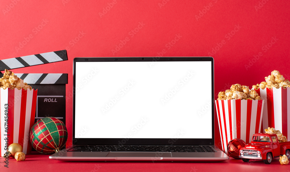 Computer Screen With Popcorn Winter staycation: side view of laptop, popcorn, baubles, movie clapper ...