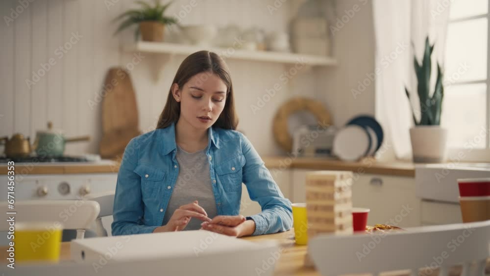 Lonely girl sitting on the right checking phone messages. Young sad woman texting in smartphone, sitting on sofa in decorated living room. Holidays concept. Female person chatting with friends online. Lonely girl sitting on the right checking phone messages. Young sad woman texting in smartphone, sitting on sofa in decorated living room. Holidays concept. Female person chatting with friends online.