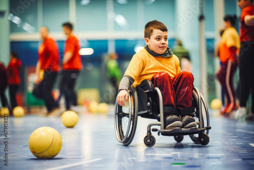 Disabled young boy player playing on wheelchair and having fun, game with ball, special needs child enjoying sport