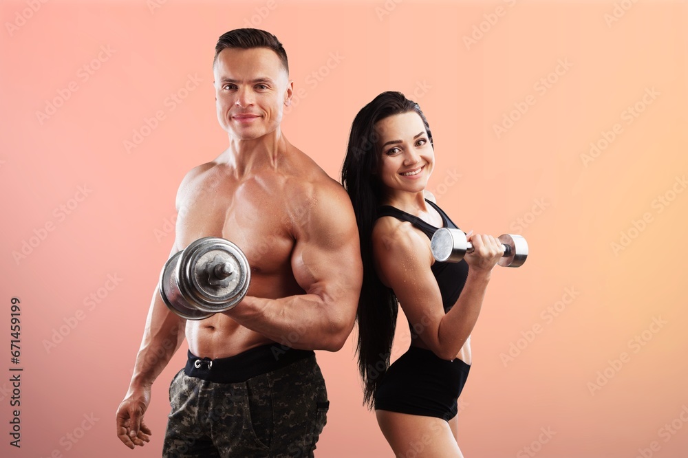 Sport young couple use dumbbells Sport young couple use dumbbells