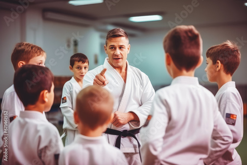 Little kids training professional judo or jiujitsu in white kimonos on, coach training them asian martial art for beginners