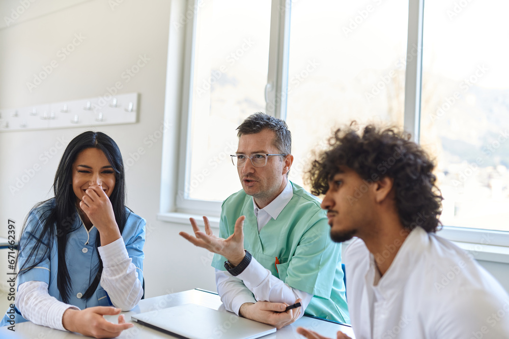 Fototapeta premium A dedicated group of doctors and medical nurses attentively listens to their colleague's work plan in a healthcare facility, fostering collaboration and ensuring high-quality patient care