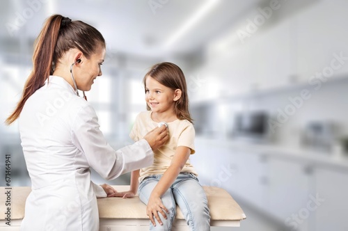 Pediatrician doctor examining cute child in clinic  AI generated image