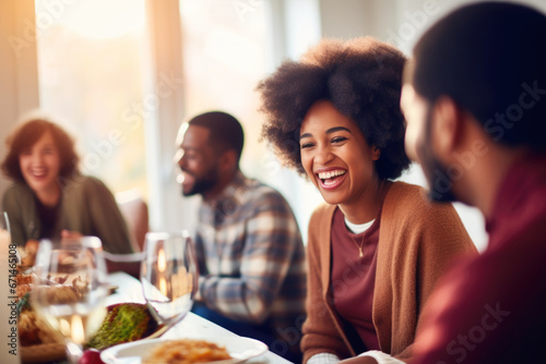 African American family having dinner during thanksgiving day. Happy people celebrating holiday, eating and laughing together