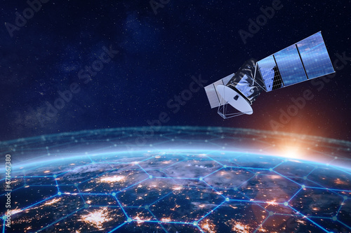 Telecommunication satellite providing global internet network and high speed data communication above Europe. Satellite in space, low Earth orbit. Worldwide data communication technology. photo