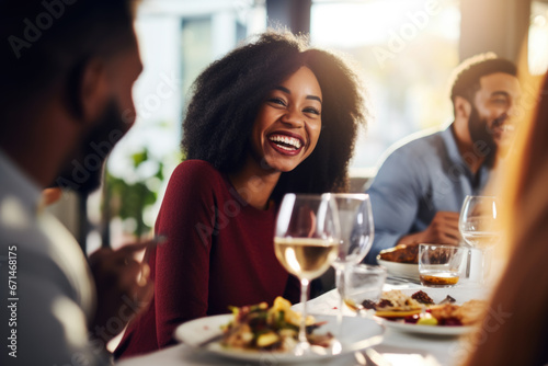 African American family having dinner during thanksgiving day. Happy people celebrating holiday, eating and laughing together