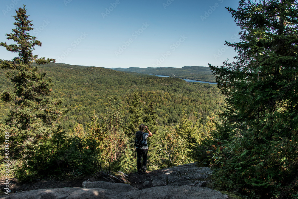 Girl hiking in the Forest near lake in La Mauricie National Park Quebec, Canada on a beautiful day