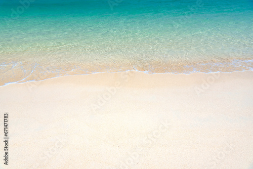 Fantastic golden sand beach with clear blue water. Summer outdoor nature holiday serenity. Beautiful clean sandy beach with soft blue ocean wave. Background, copy space or space for text.
