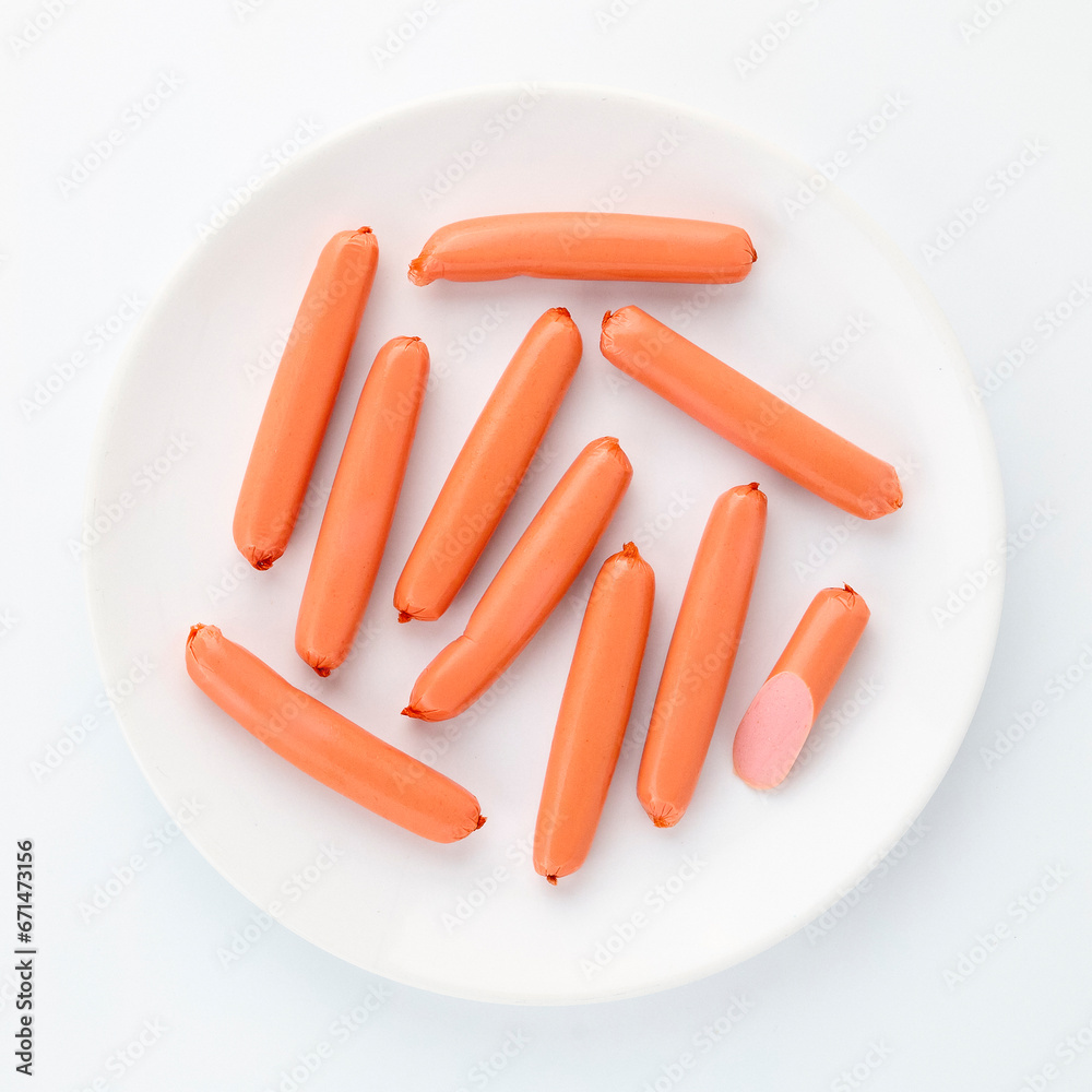 Boiled chicken sausages on white background close up top view isolated on round plate for your design. Healthy food. Protein, vitamins Boiled chicken sausages on white background close up top view isolated on round plate for your design. Healthy food. Protein, vitamins