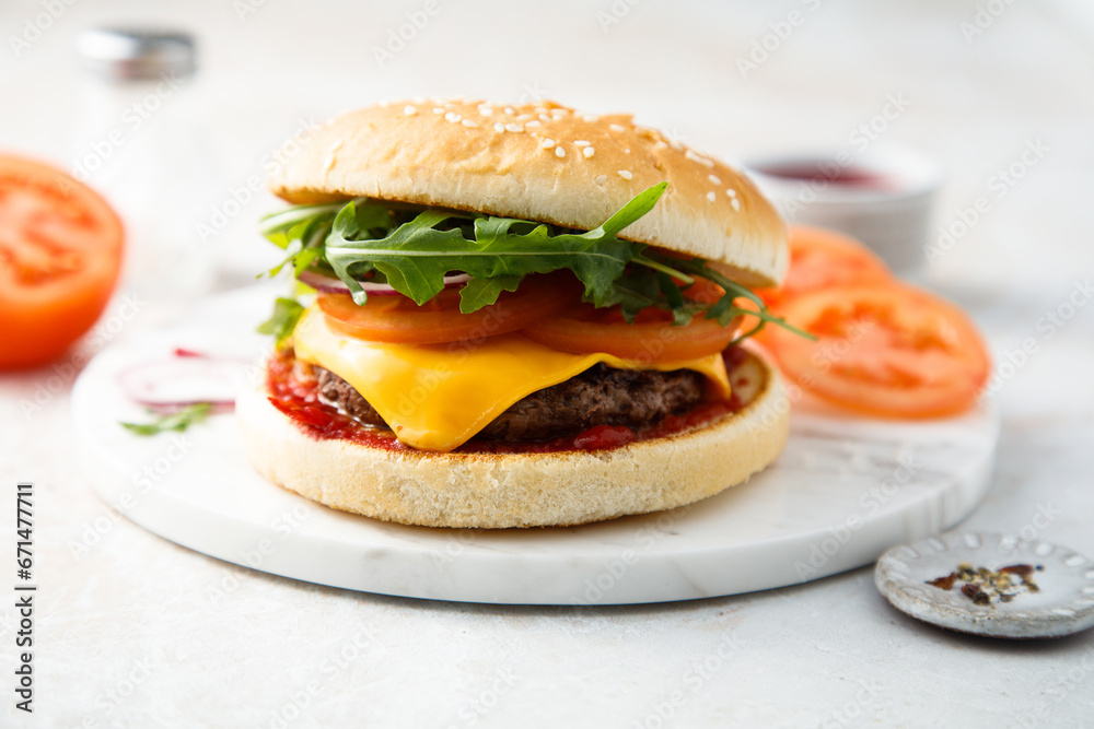 Traditional homemade cheeseburger with arugula Traditional homemade cheeseburger with arugula